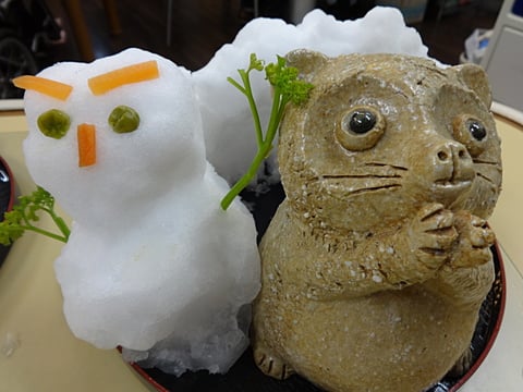 だんちデイのマスコット「タヌキちゃん」と雪だるま